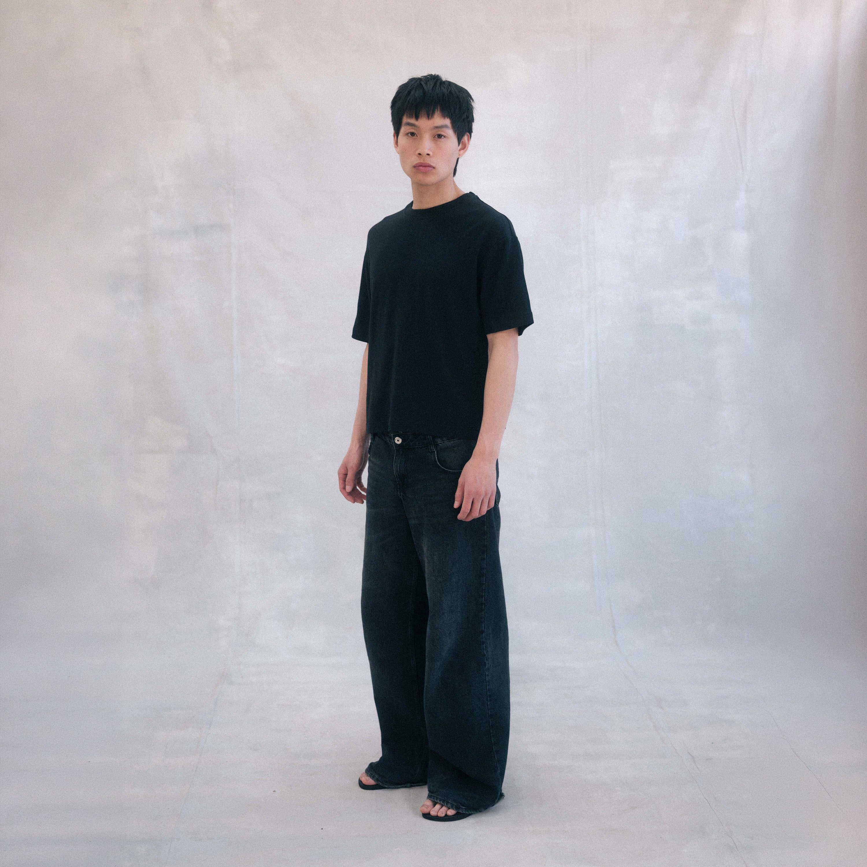 The Box Tee in black heavy merino wool, model wearing front view