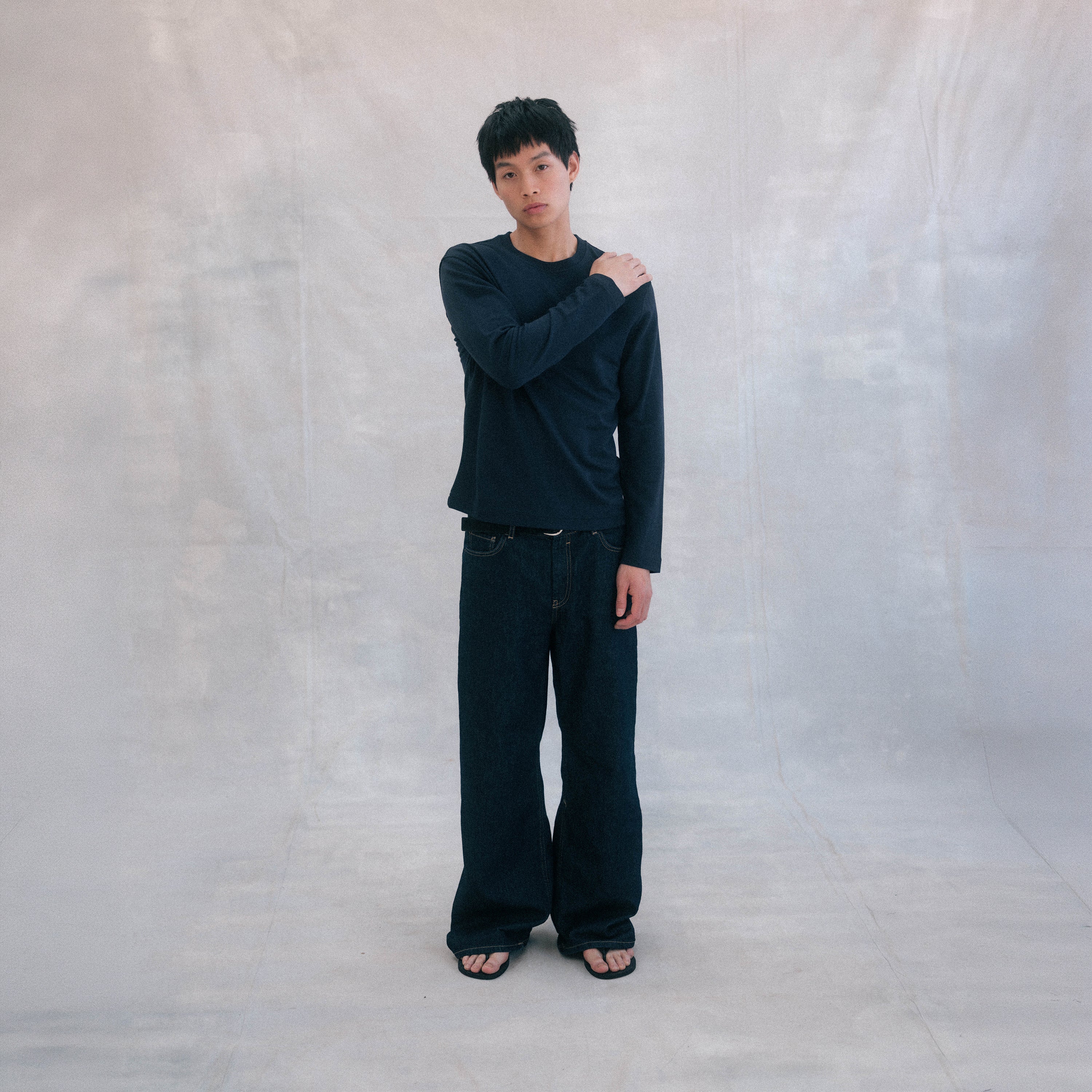 The Lightweight Sweatshirt in blue heavy merino wool, model wearing side view